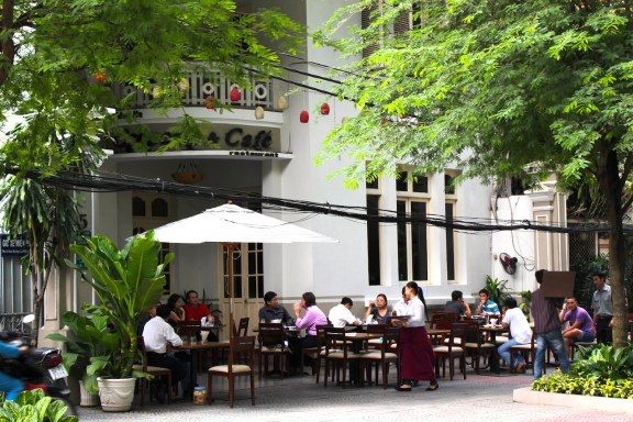 Locals enjoying crepes and coffee at a popular café, housed in a lovely French colonial villa. 