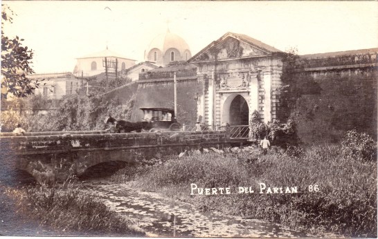 Vintage view of a calesa (horse carriage) exiting the Parian Gate, Walled City of Manila. 
